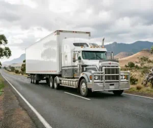 Large white semi-trailer truck on a rural Australian highway.